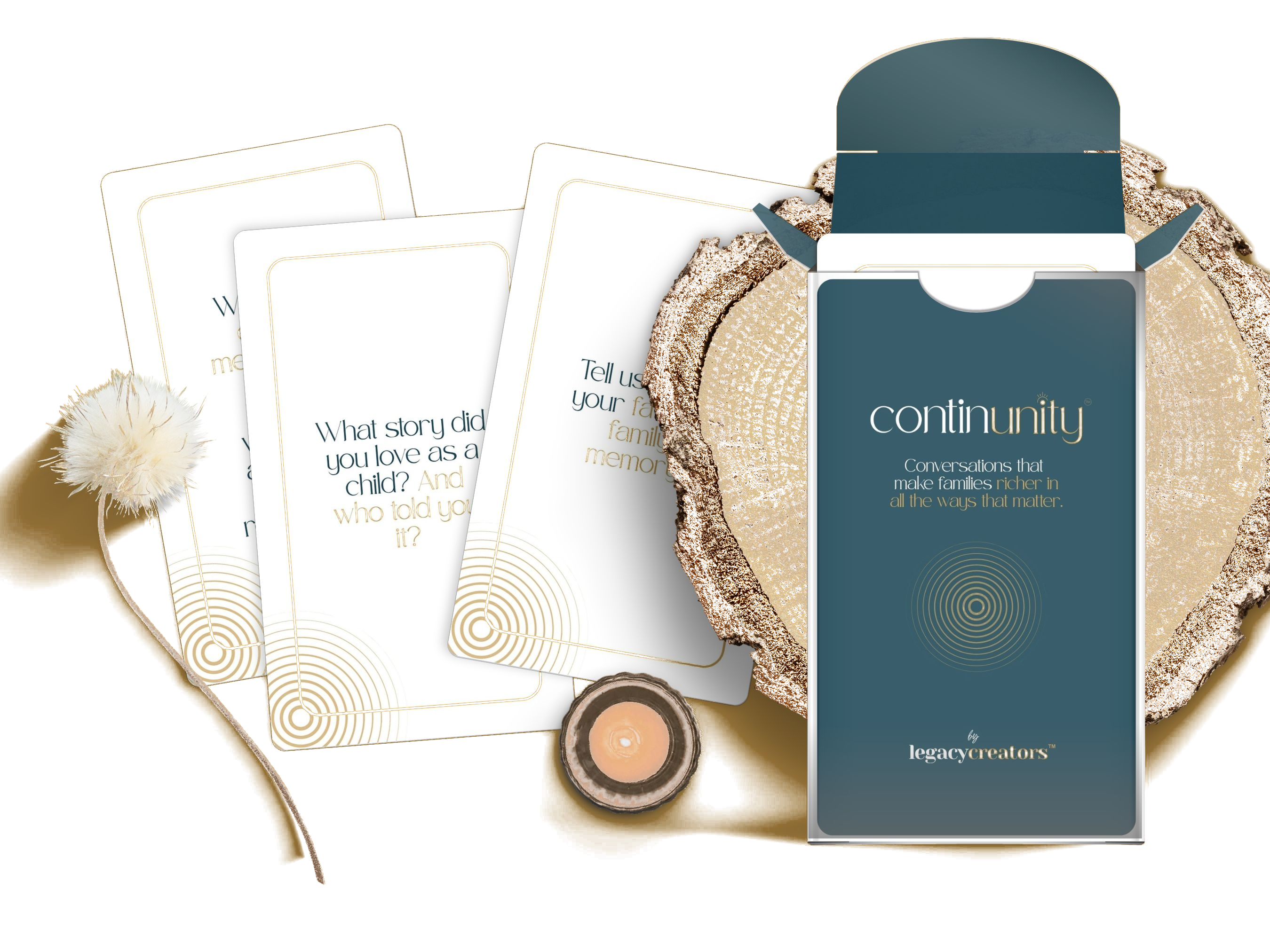 ContinUnity Conversation Cards in a teal box with sample cards fanned out, on a wood slab with dried flowers and a candle.